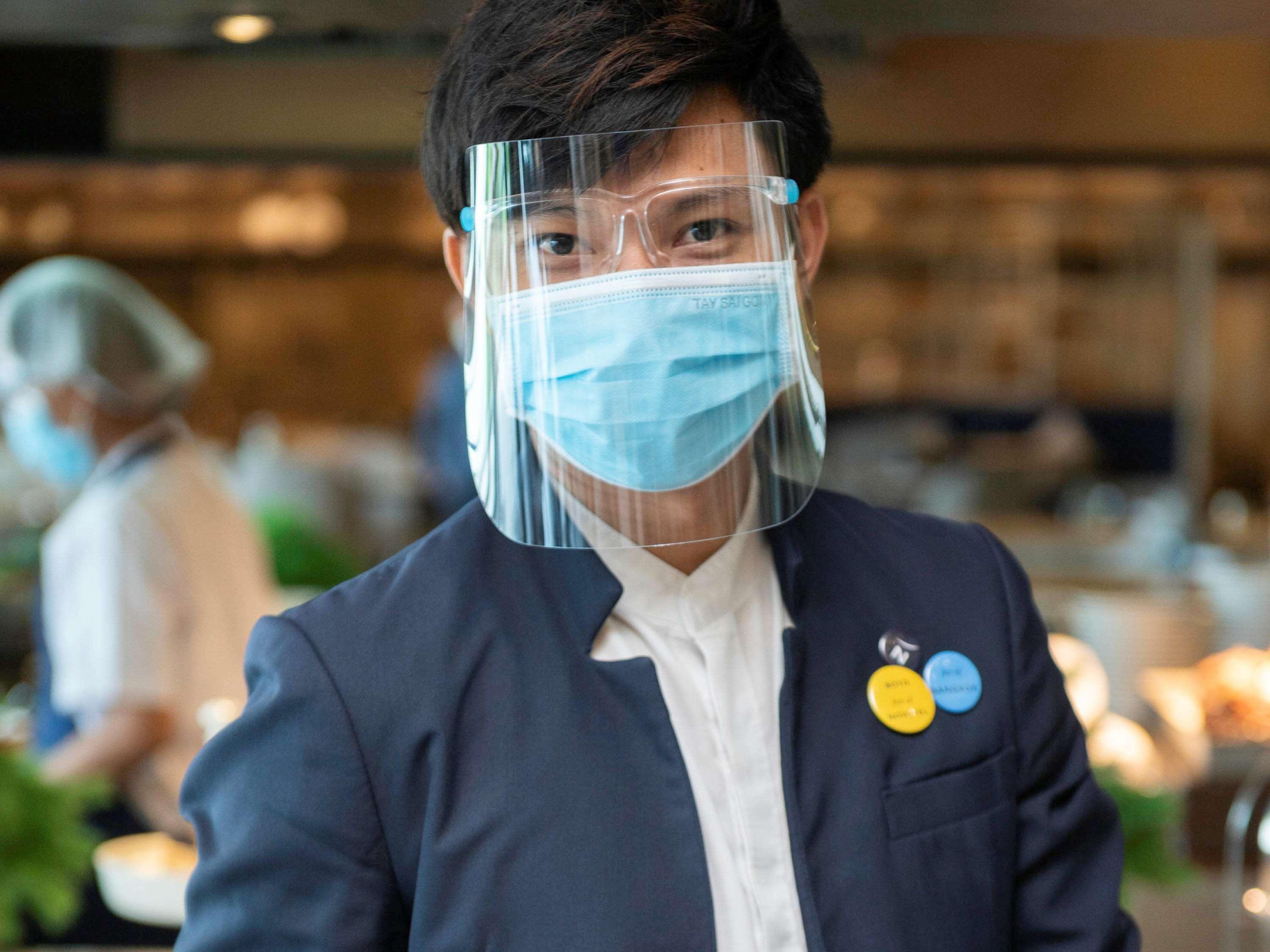 Novotel Chennai Sipcot Екстериор снимка A Thai Airways employee wearing a face shield